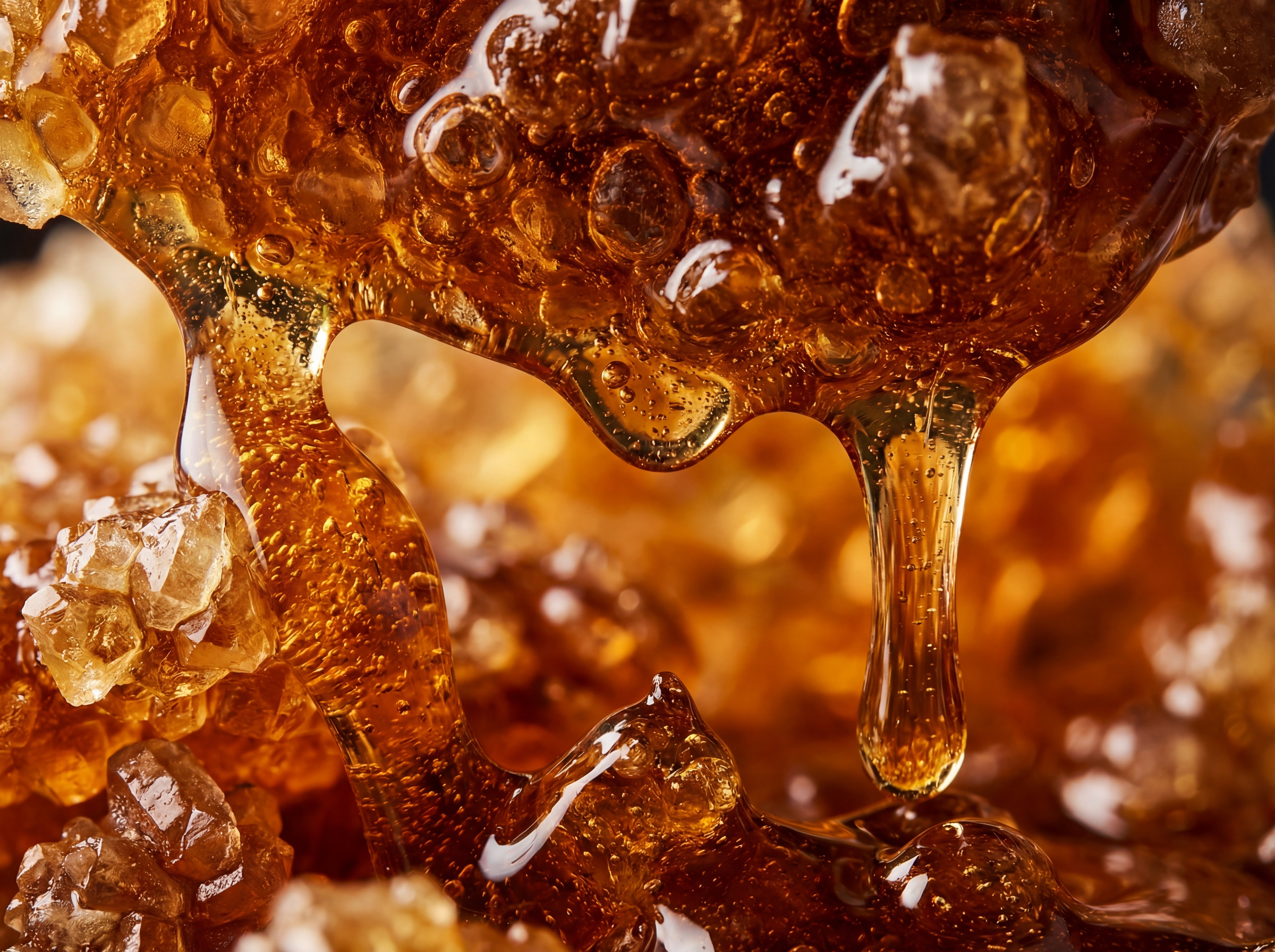 Macro photograph of caramelised sugar showing golden-brown colour transformation and crystalline structure
