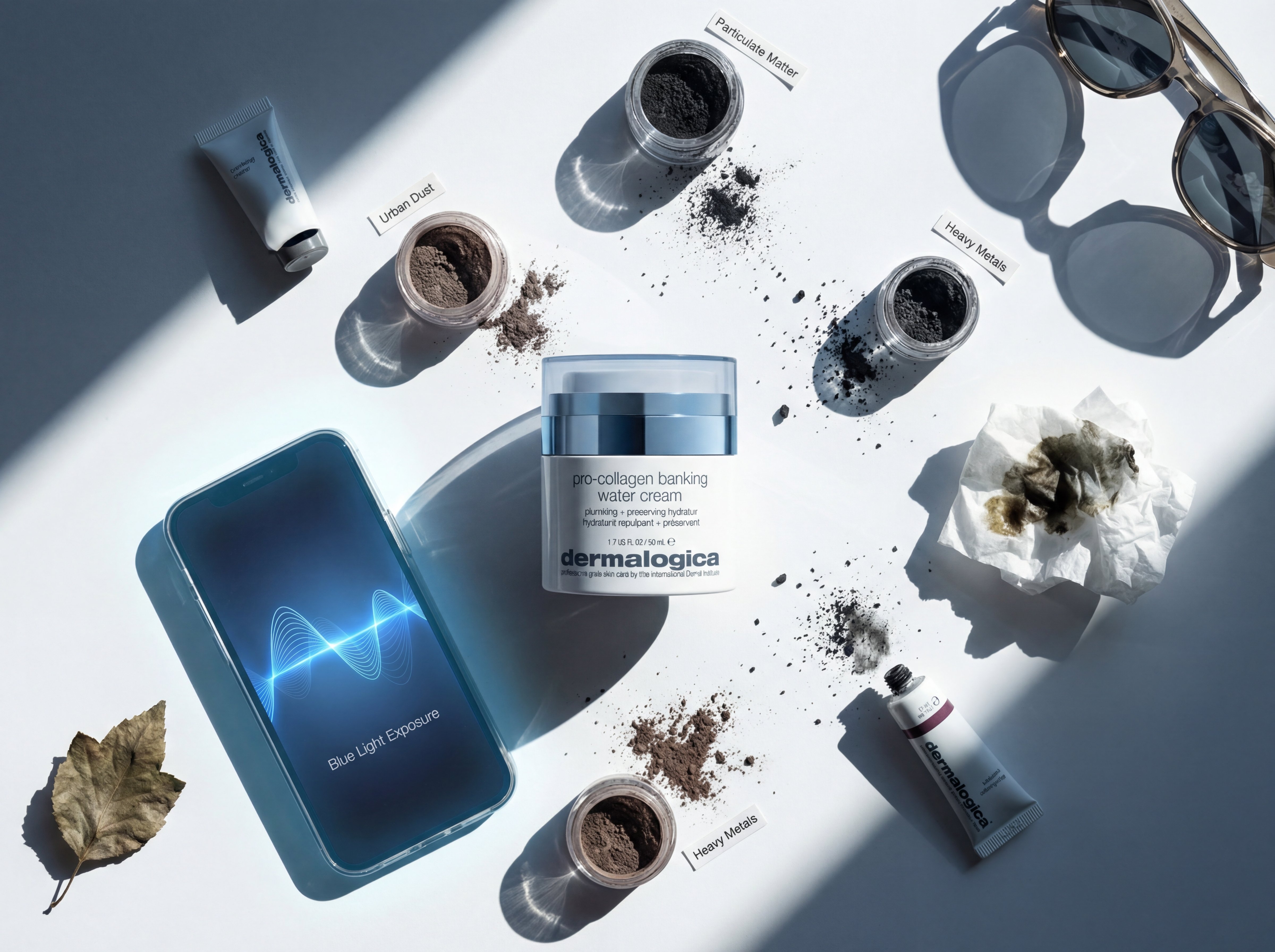 Flat lay showing environmental stressors including blue light from phone, pollution particles, and harsh sunlight representing oxidative stress triggers