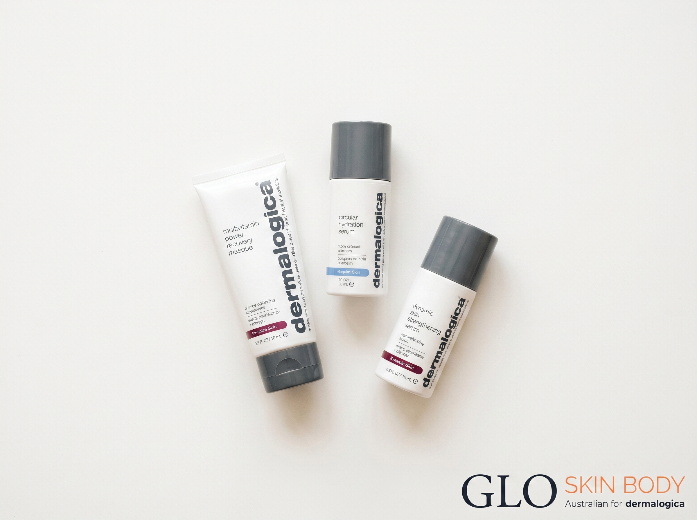 Flat lay of Dermalogica Multivitamin Power Recovery Masque, Circular Hydration Serum, and Dynamic Skin Strengthening Serum on a warm white surface