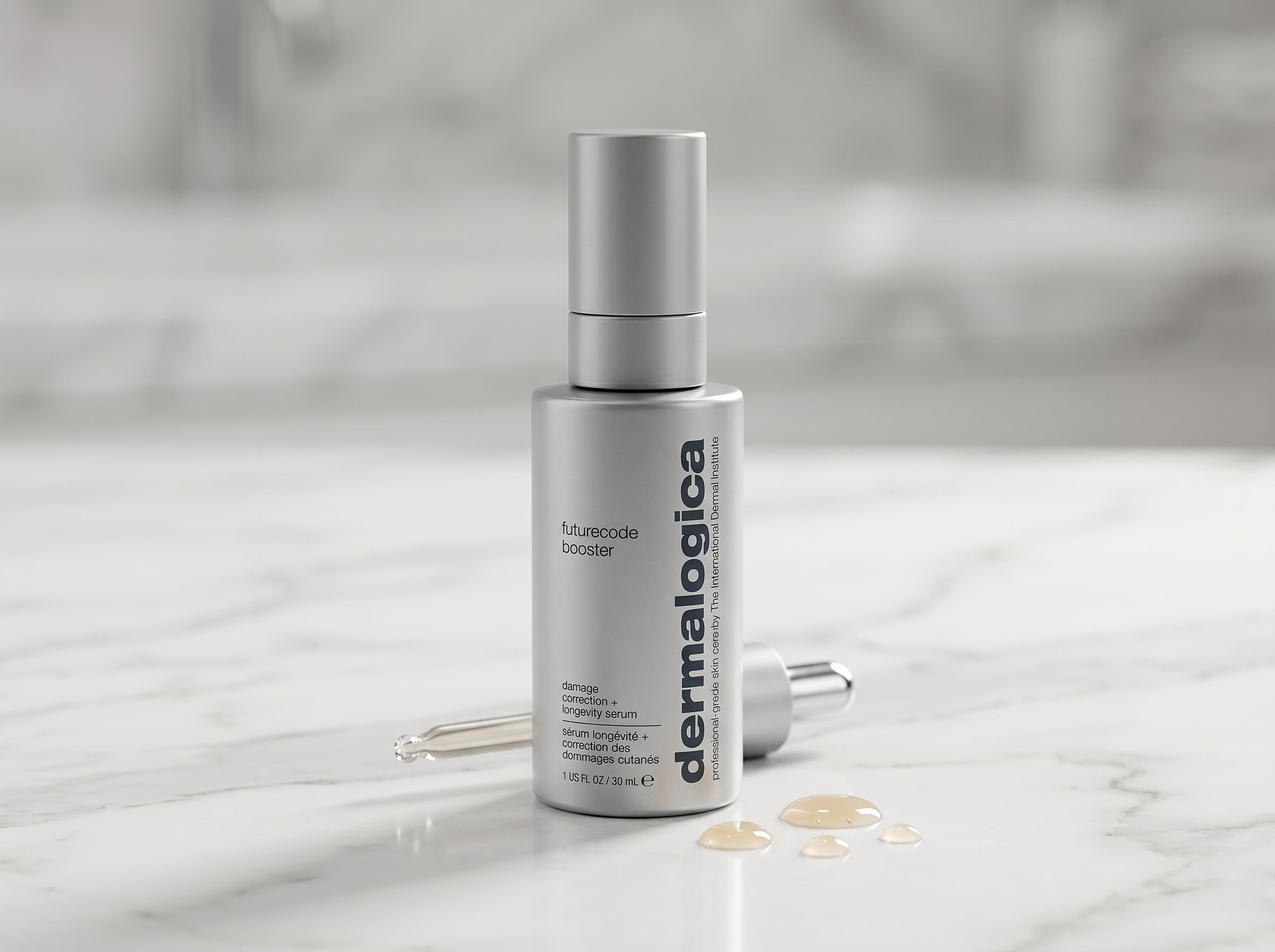 Dermalogica FutureCode Booster serum bottle on white marble with serum droplets beside it, clean studio lighting