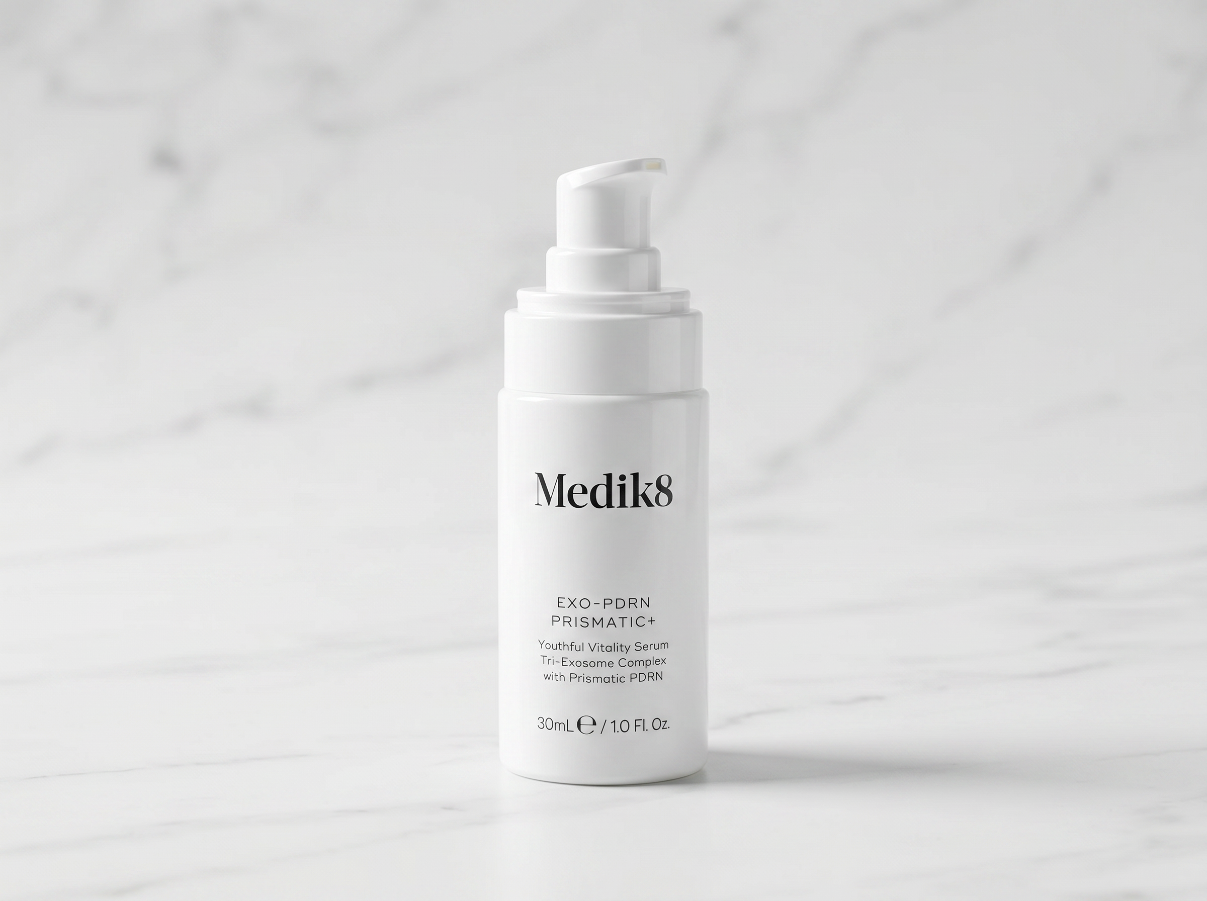 Exo-PDRN Prismatic+ serum bottle and dropper displayed on white marble surface in soft studio lighting