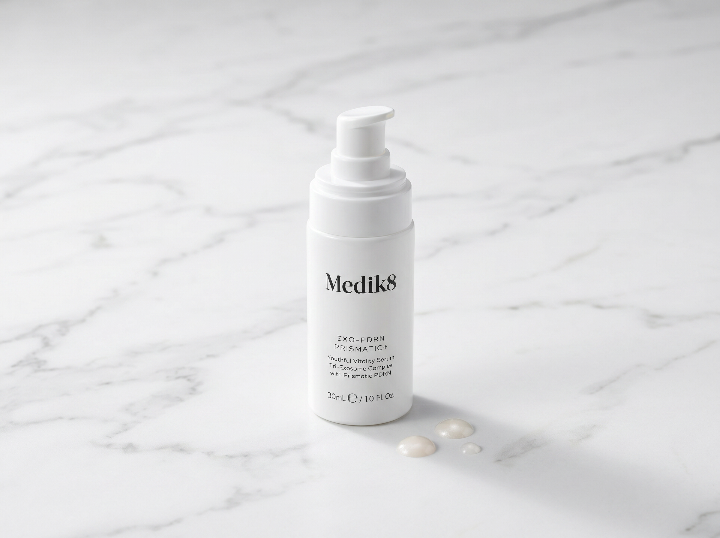 Medik8 Exo-PDRN Prismatic+ serum bottle on white marble surface with serum droplets, clean studio lighting