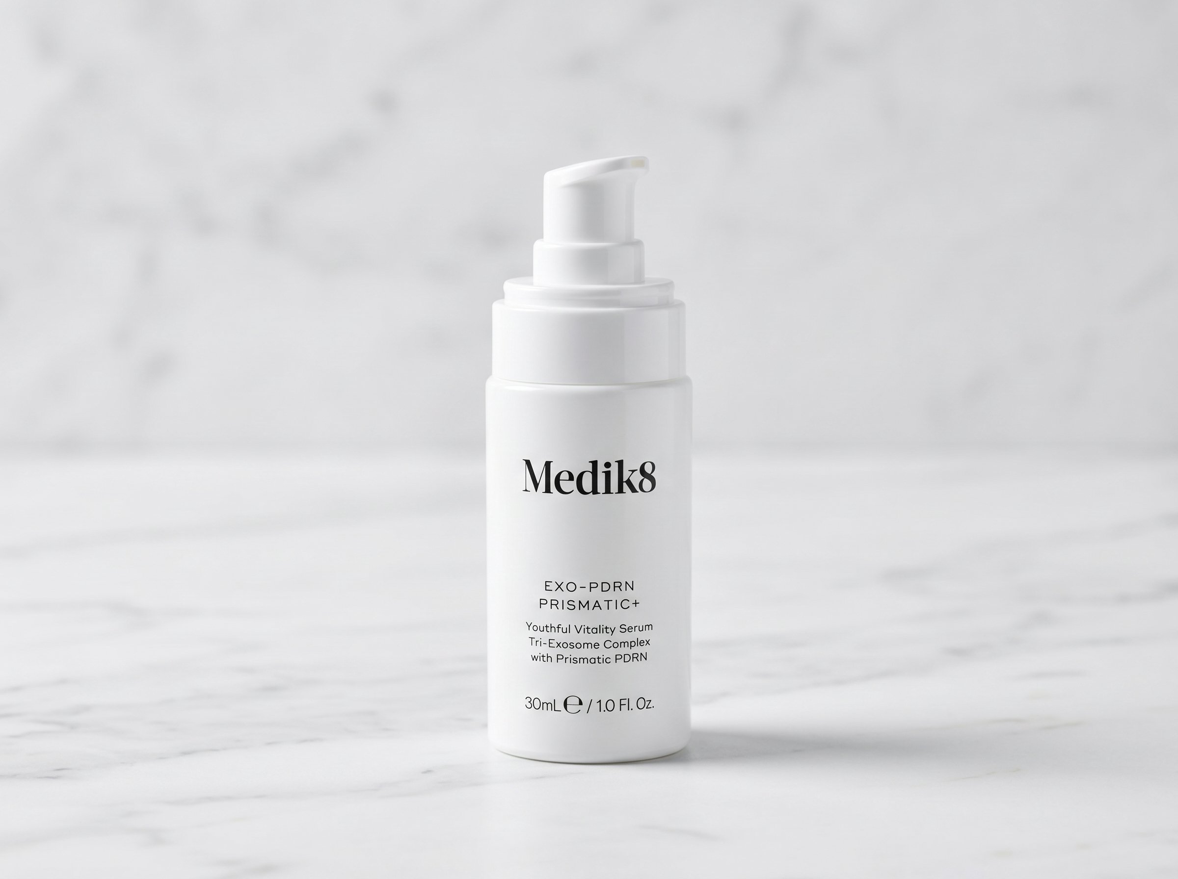 Medik8 Exo-PDRN Prismatic+ serum bottle on white marble surface with soft studio lighting