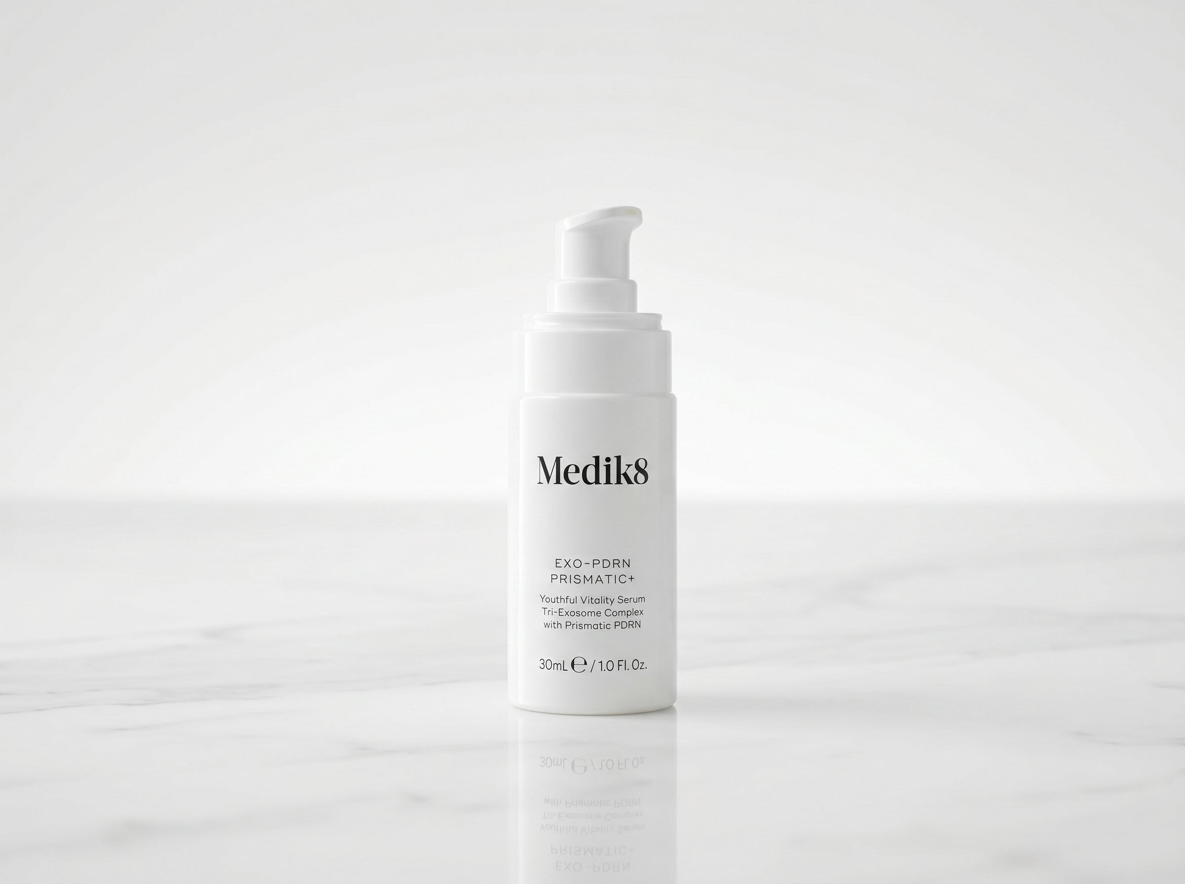 Medik8 Exo-PDRN Prismatic+ serum bottle on white marble surface under soft studio lighting
