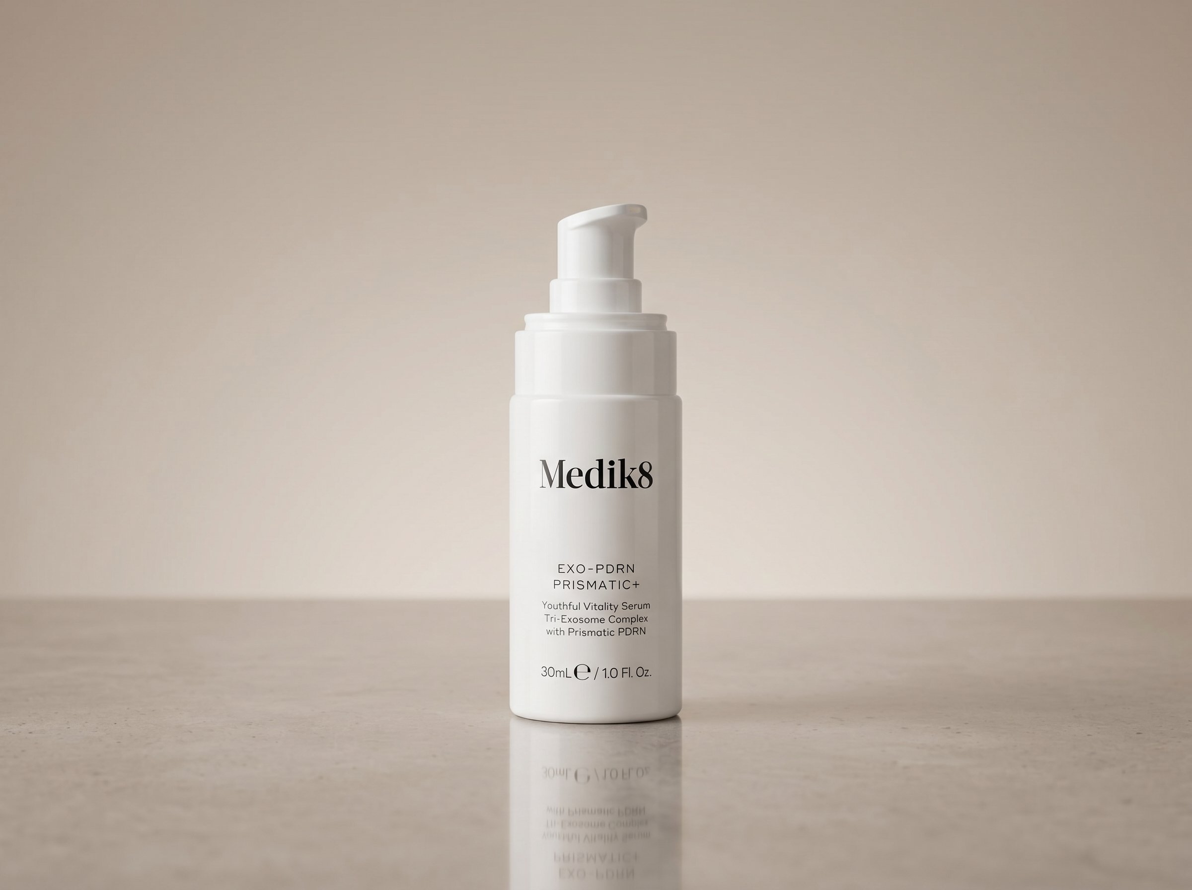 Exo-PDRN Prismatic+ serum bottle photographed on a clean minimal surface with soft studio lighting