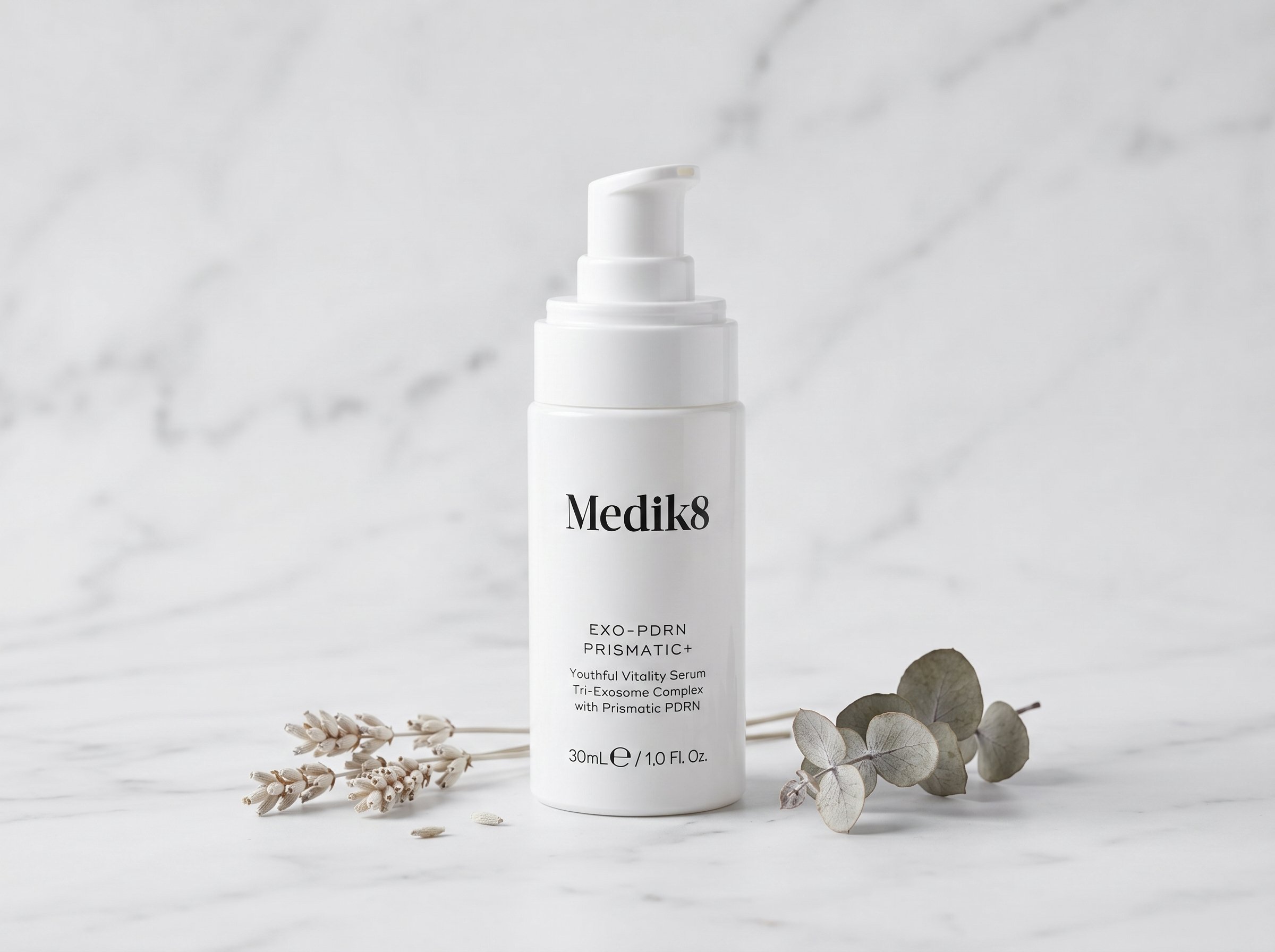Exo-PDRN Prismatic+ serum bottle on white marble surface with soft studio lighting