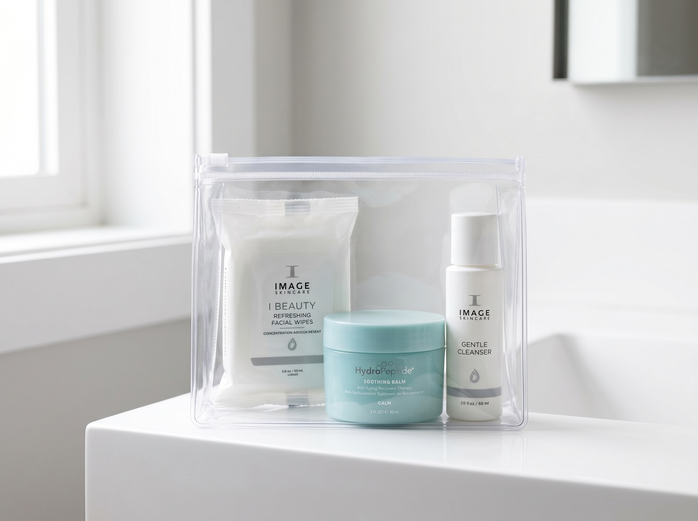 Clear travel pouch containing HydroPeptide Soothing Balm, facial wipes, and a gentle cleanser as a simplified in-flight
