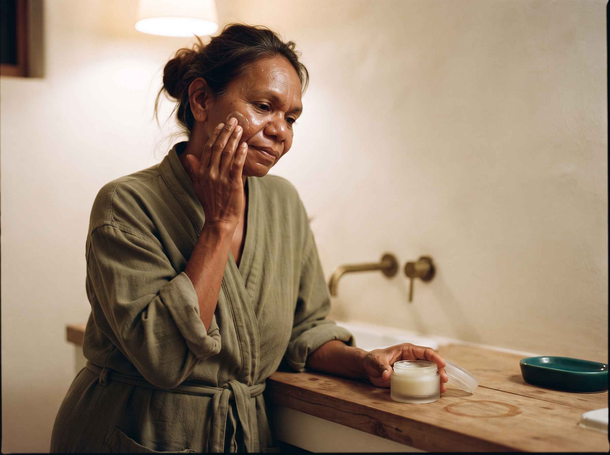 Person applying soothing balm to face indoors after a day in cold weather