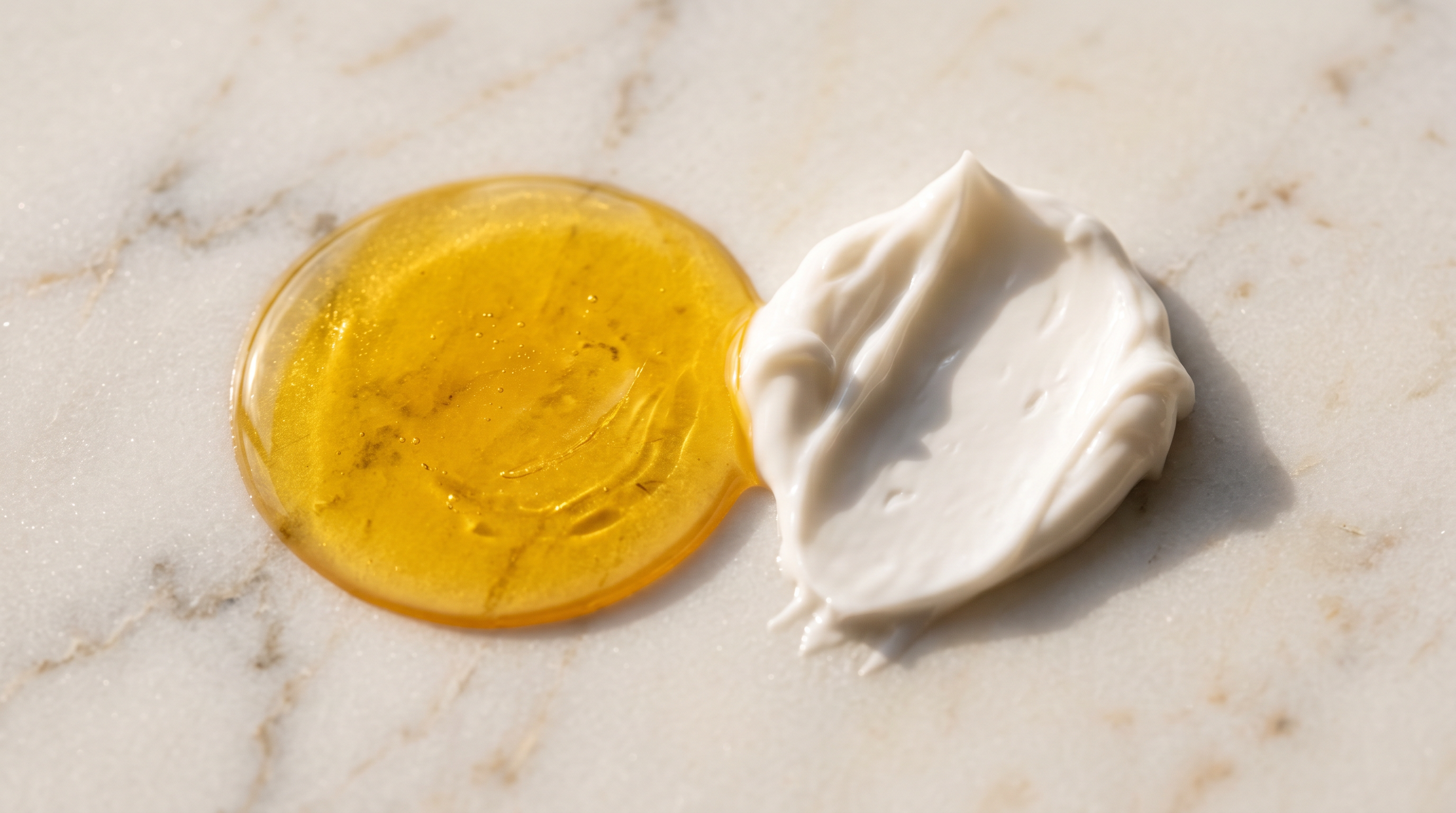 Close-up of skincare textures representing an exfoliating acid and a soothing moisturiser